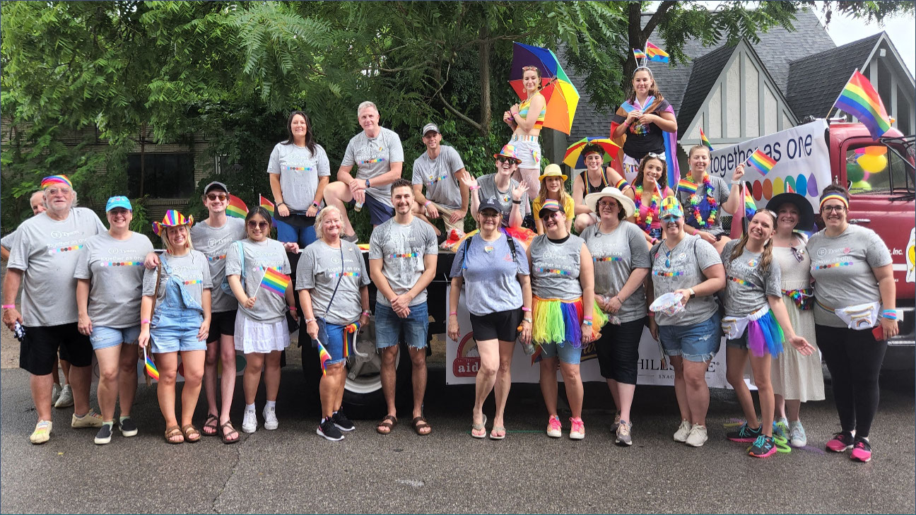This is a group photo of team members that participated in a Pride Parade.