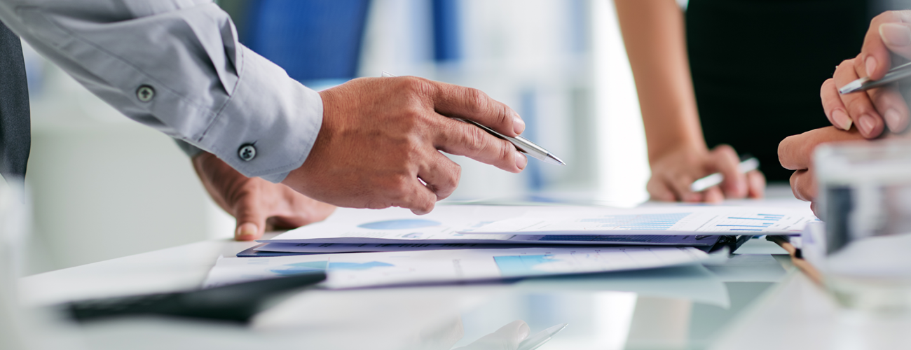 Hand holding pen over a document