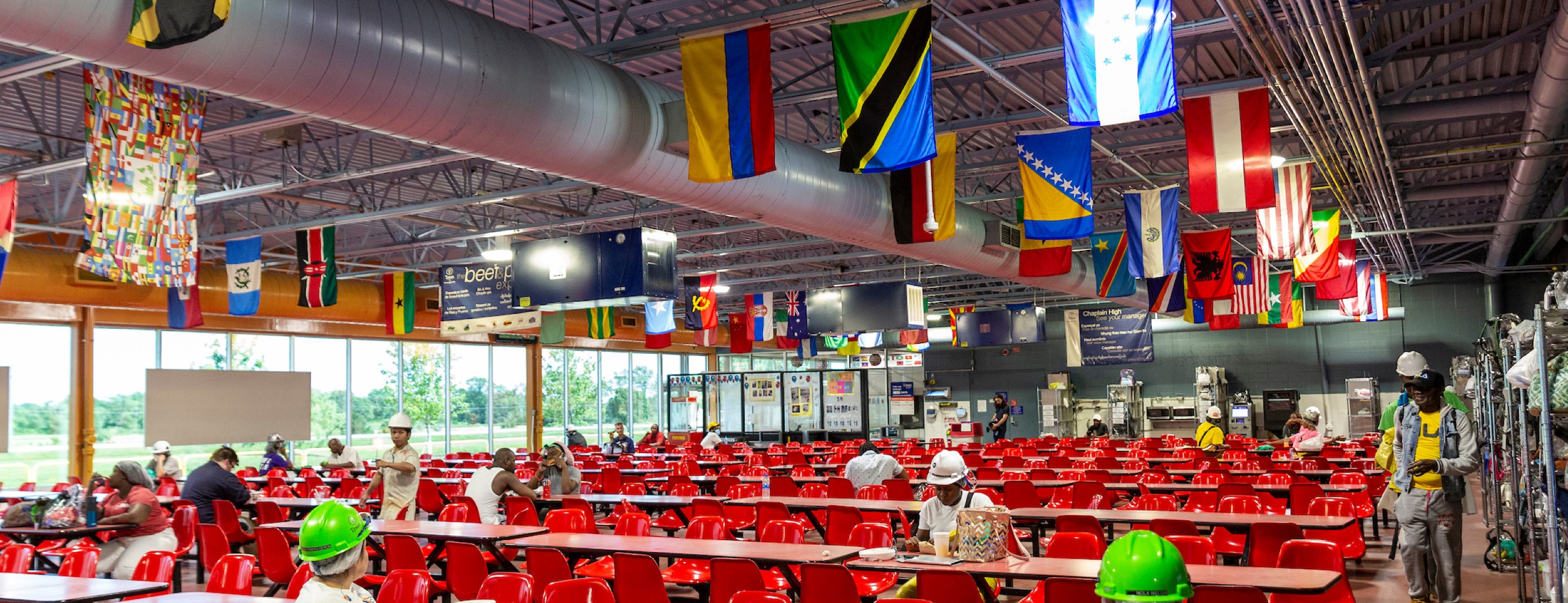 This is an image of a Tyson Foods cafeteria that has international flags on the ceiling.