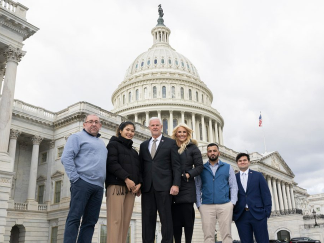 This is a photo of team members in front of a capitol building.