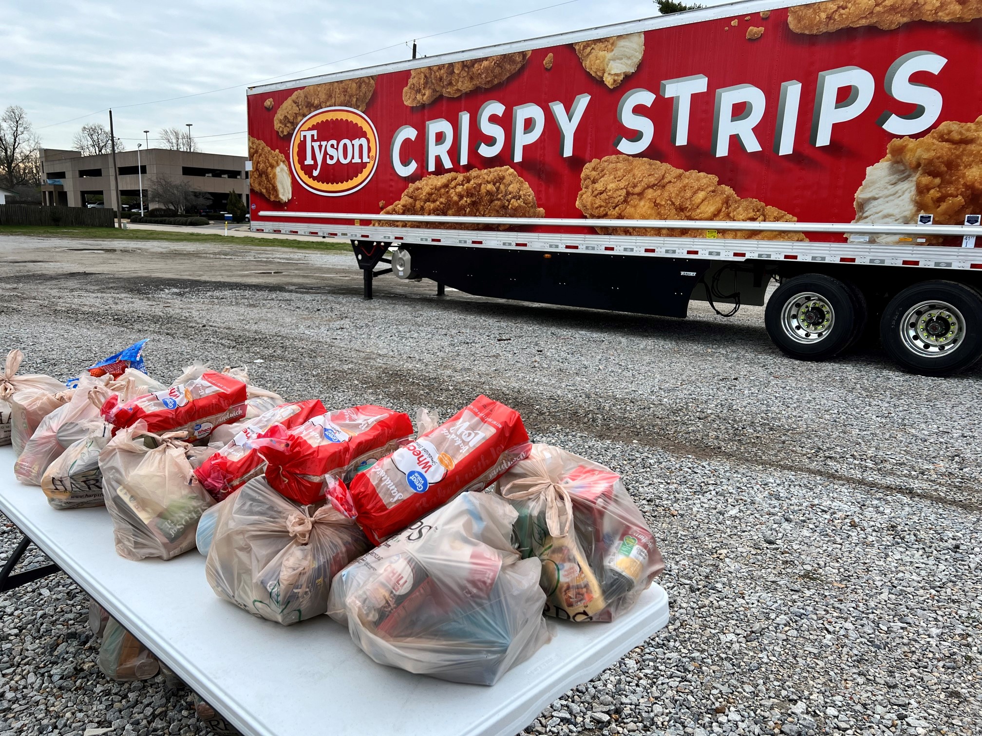 A photo of a Tyson truck and bags of food. 