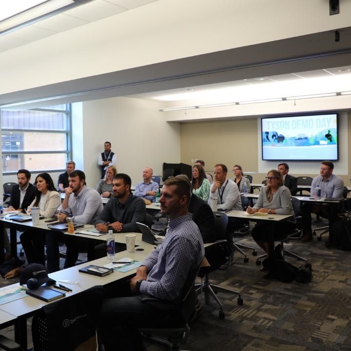 This is a photo of people in a room during a virtual conference.