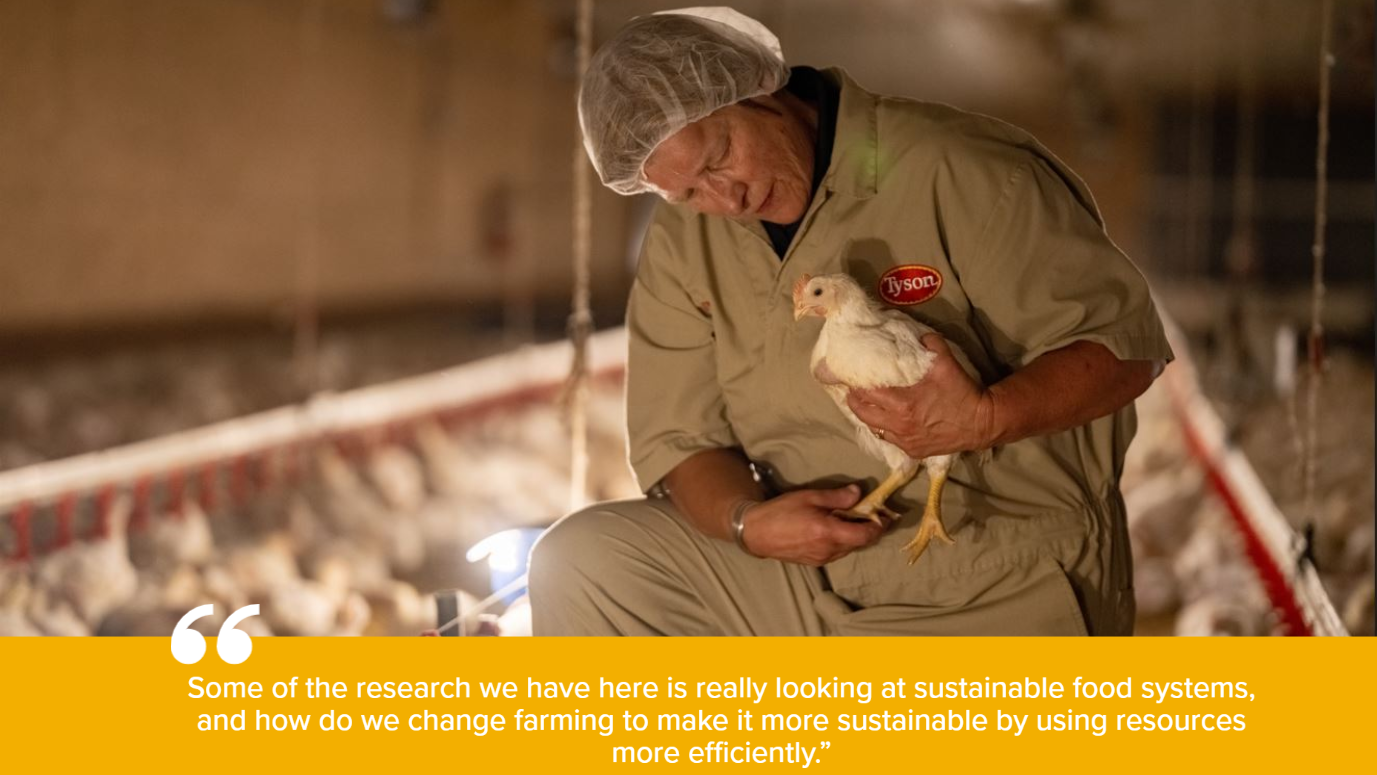 Image of a woman holding a chicken while saying, "Some of the research we have here is really looking at sustainable food systems, and how do we change farming to make it more sustainable by using resources more efficiently.”